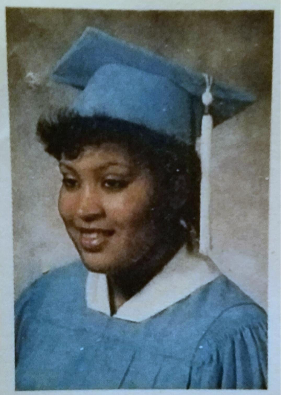 Graduate in cap and gown portrait photo