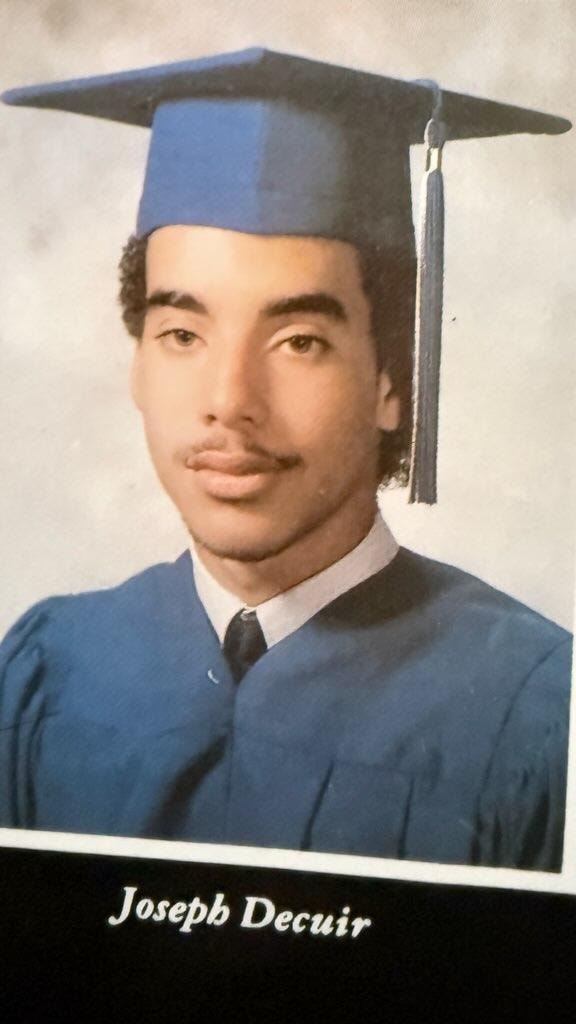 Joseph Decuir graduation portrait in cap and gown