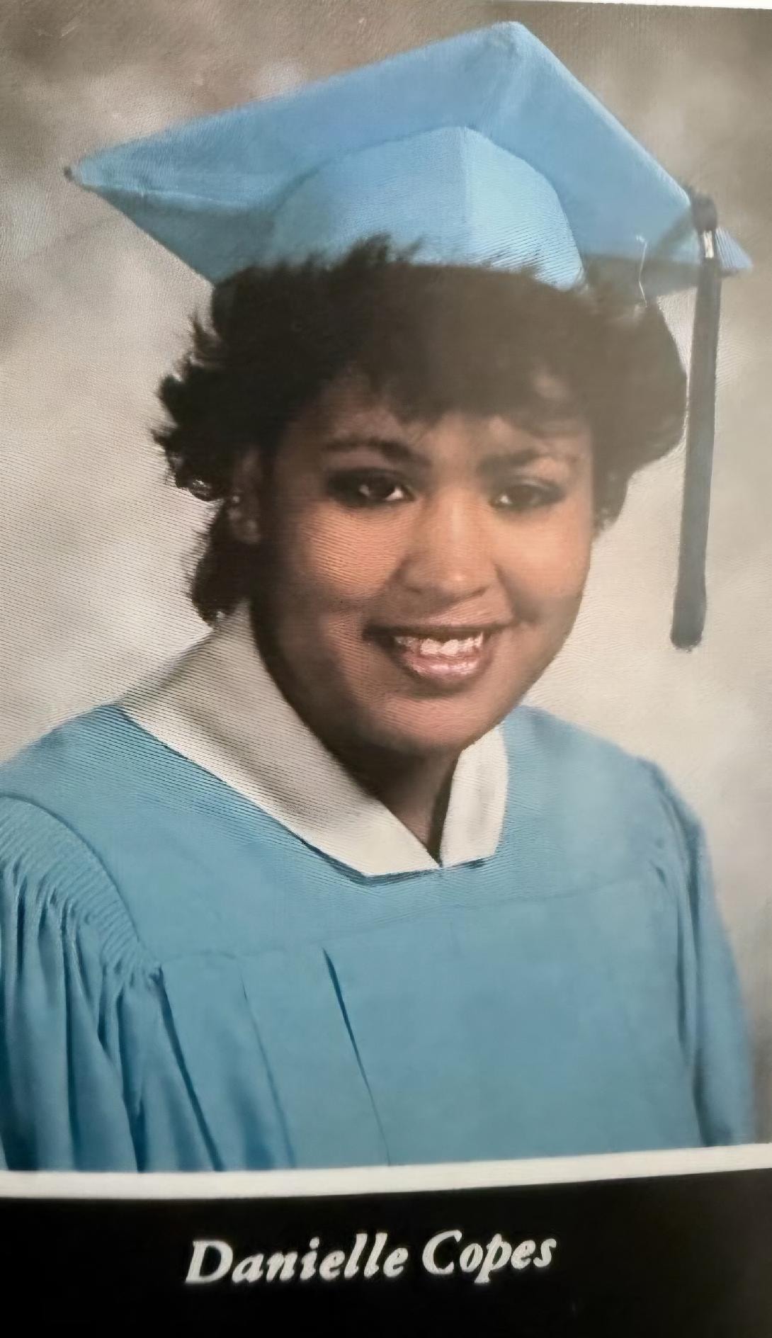 Danielle Copes graduation portrait in cap and gown