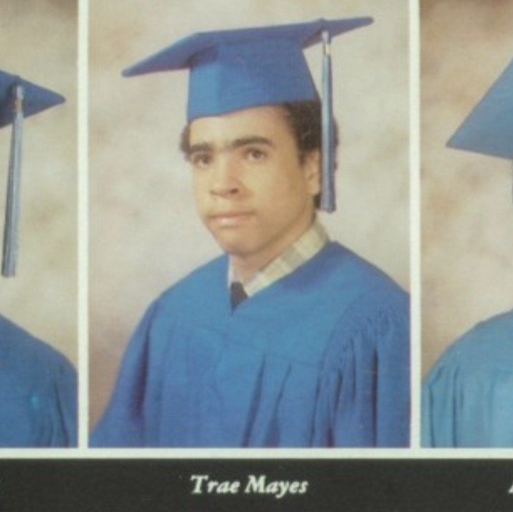 Trae Mayes yearbook graduation portrait in blue cap and gown