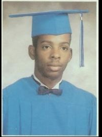 Graduate in blue cap and gown with bow tie portrait