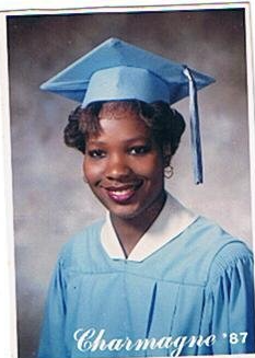 Charmagne graduation portrait in light blue cap and gown, Class of 1987