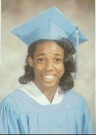 Young woman in light blue cap and gown graduation portrait