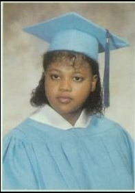 Young woman in light blue cap and gown graduation portrait