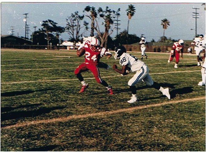 Washington Generals football player #24 in red uniform running with the ball during a game