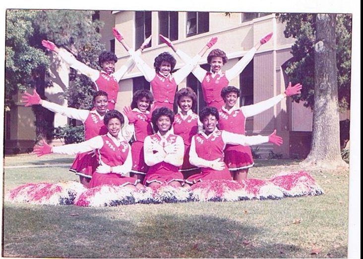Washington Generals cheerleading squad in red and white uniforms posing in formation outdoors